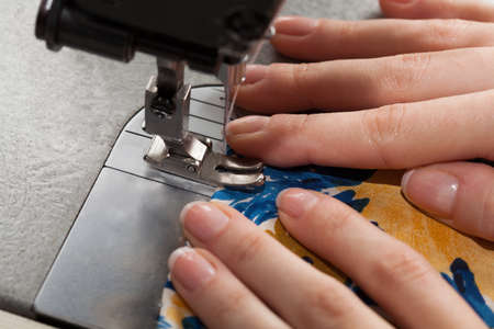 Closeup of dressmaker's hands and a dress