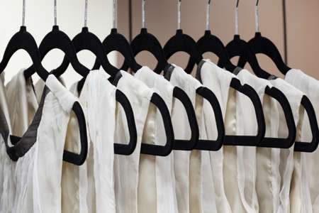 Closeup of dresses hanging on hangers, dressmakerの写真素材