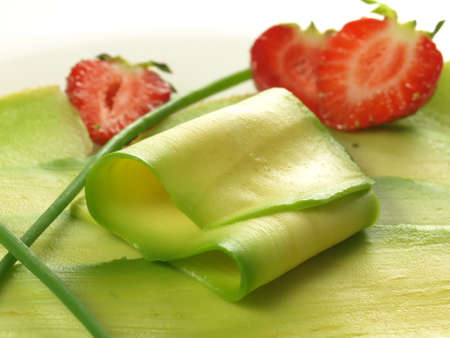 Slices of avocado with halves of strawberries