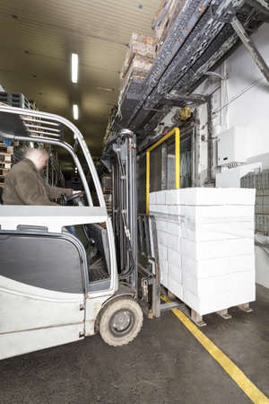 Working forklift with a palette, vertical view