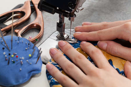 Tailor sewing on a sewing machine