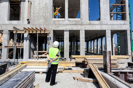 Manager of a building site looking on a structure