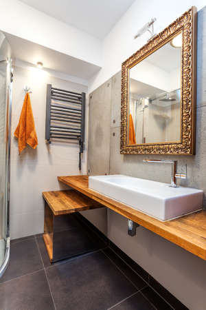 Interior of a new luxury bathroom with golden mirrorの写真素材