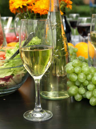 Closeup of glass with white wine on black tableの写真素材