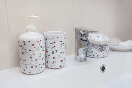 Bright space - a sink with a tap and ornamented conteinersの写真素材