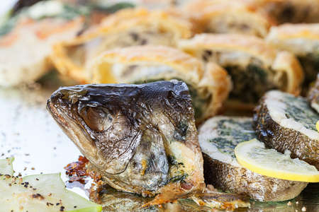 A head of a baked sea fish, closeupの写真素材