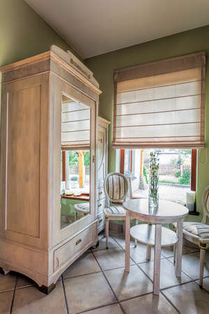 Mediterranean interior - an off-white wooden closet with a mirrorの写真素材