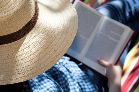 A closeup of a female reader wearing a hatの写真素材