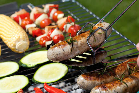 A close up of a grilled white sausage with rosemaryの写真素材