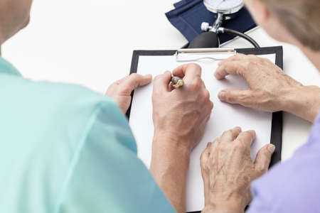 Bird eye view of nurse taking notes for a patient
