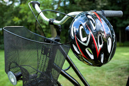 Basket and helmet of a bike in the parkの写真素材