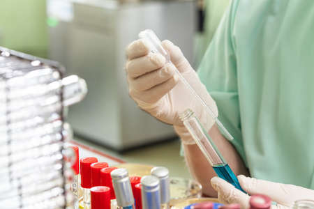 Substance taken through pipette from test tube in laboratoryの写真素材