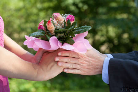Man giving a bouquet of flowers to his ladyの写真素材