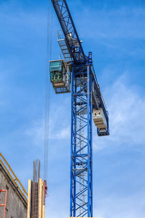 Vertical view of a huge crane on sky backgroundの写真素材