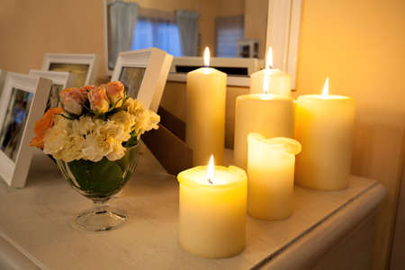 Closeup of a lighted candles on white commodeの写真素材