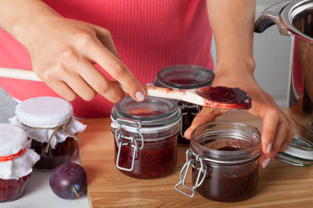 Housewife preparing fresh homemade plum jam
