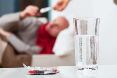 Water with soluble tablet for an ill patient