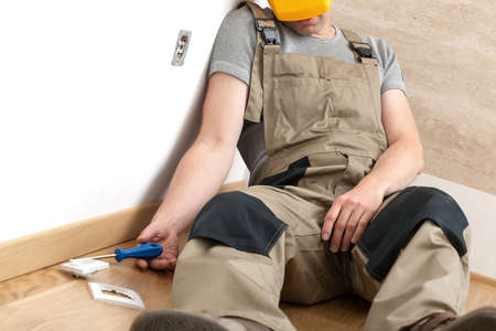 Technician stunned during electric contact repairの写真素材