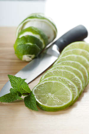 Fresh cutting juicy limes as ingredient to drinksの写真素材