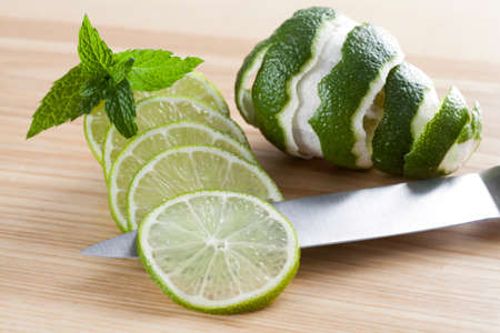 Slices of lime with skin on the cutting board