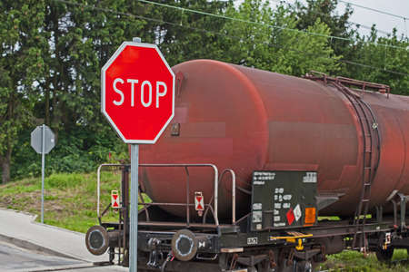 A level crossing with a red stop sign