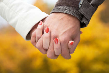 Close up of couple in love holding handsの写真素材
