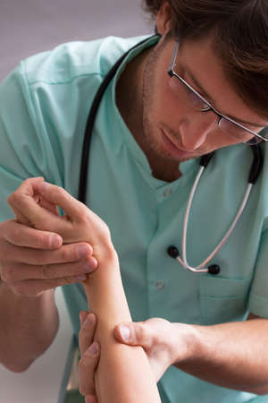 Dermatologist testing dermal changes on hand of young girlの写真素材