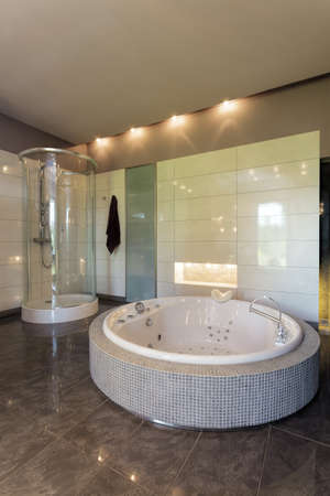 bathtub and shower in spacious bathroomの写真素材
