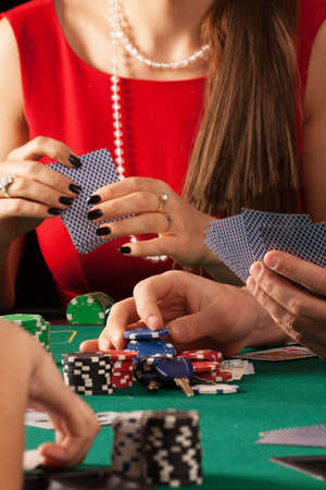 Gamblers playing poker game with cards and chips