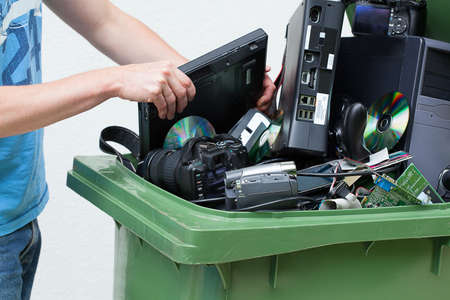  Putting used and old computer hardware into the dustbin.の写真素材