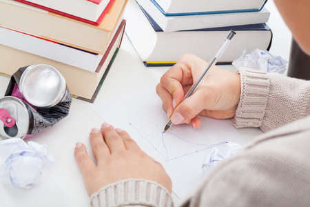 Student solving an equation and drawing a chart