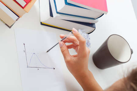 Math student analyzing chart, hard studying