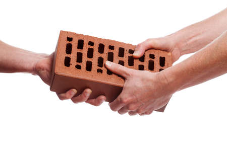 Two hands giving a brick on white backgroundの写真素材