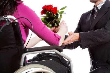 A man proposing to a disabled woman on a wheelchairの写真素材