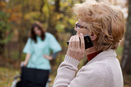 Elder disabled woman talking on the mobile phoneの写真素材