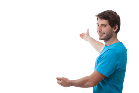 Man in casual outfit presenting an empty spaceの写真素材
