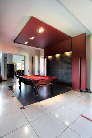 An elegant black and red hall with a pool table