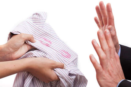 Husband cought redhanded, wife with kissed shirtの写真素材