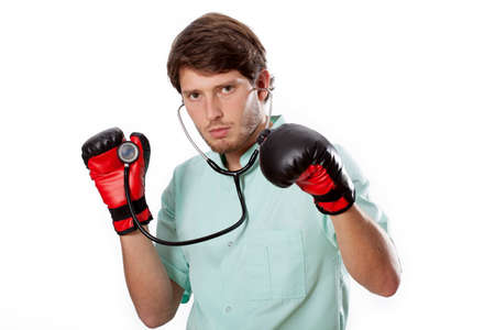 Fighting doctor with stethoscope on an examinationの写真素材