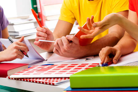 Young and active group of students learning to exam together