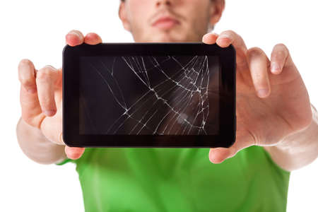 Student presenting a broken black tablet behind glassの写真素材
