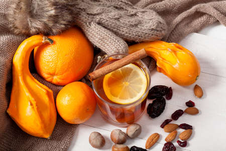 Winter fruits and drink, hot tea and orangesの写真素材
