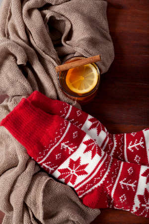 Warm winter red socks and cup of hot teaの写真素材