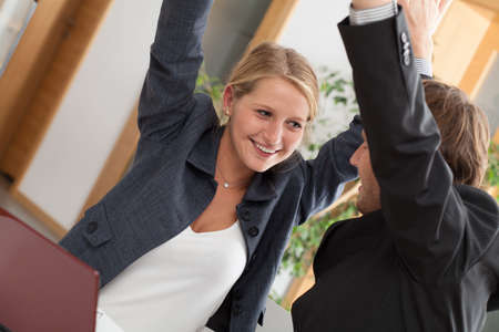 Business partners celebrating successful cooperation in office