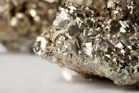 Golden pyrite stone specimen with shiny reflectionsの写真素材