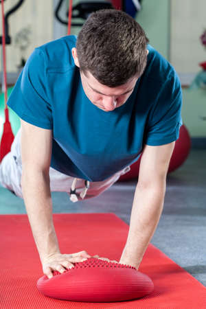Strong man during gymnastic in sport center