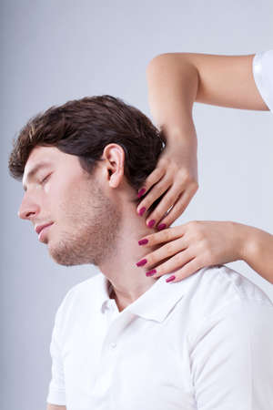 Specialist doing relaxing neck massage at spa centerの写真素材