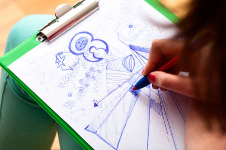 A creative student drawing instead of making notes at class