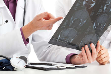 Physician looking at x-ray and debating about results
