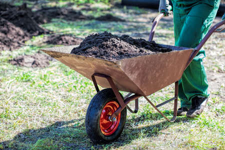 Worker with a wheelbarrow full of compostの写真素材